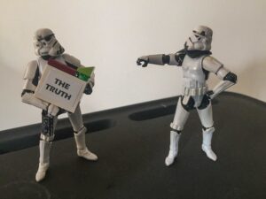 Stormtroopers with "the Truth" sign.
