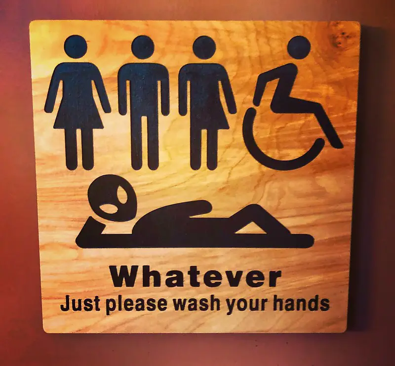 Bathroom sign saying be what you want "just wash your hands"