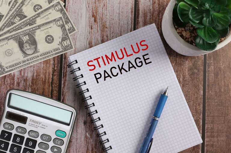 Stimulus Package written on a pad of paper.