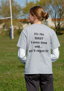 Woman wearing a "Hit Me Baby One More Time" shirt.