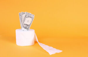 Money coming out of a roll of toiletpaper