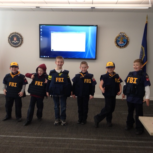 Kids lined up wearing FBI costumes