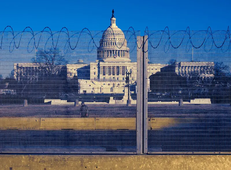 Capital Building behind barbed wire fence.