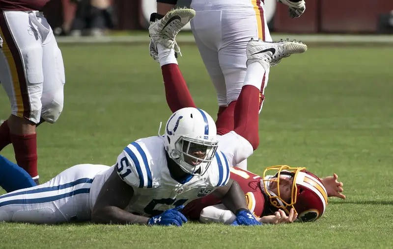 Redskins player laying on back after tackle.