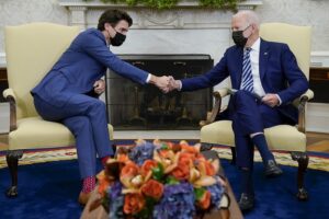 Biden and Trudeau shaking hands while wearing masks