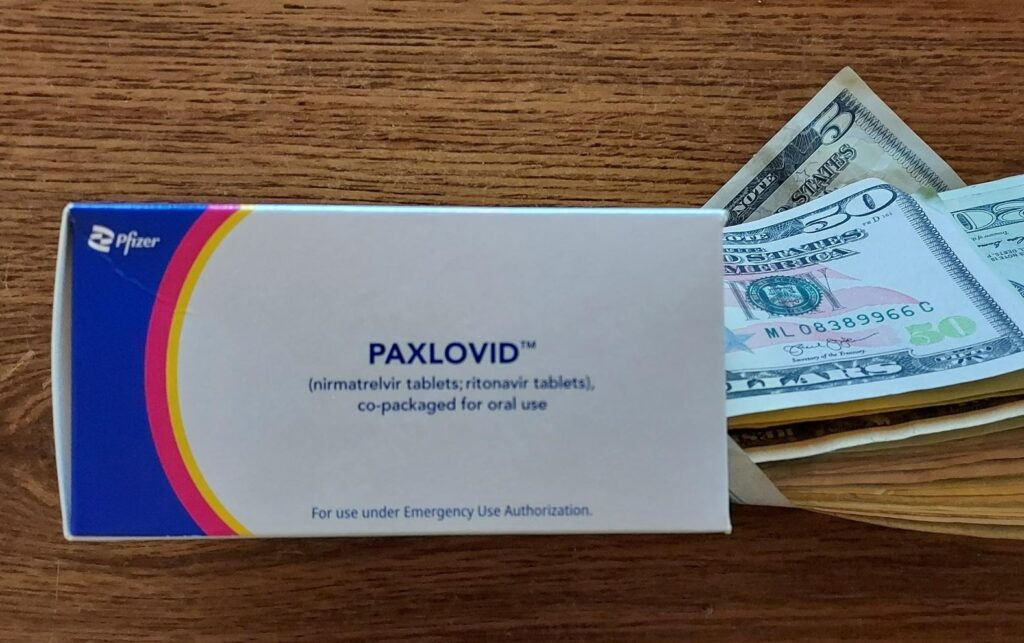 Paxlovid Box with Money coming out.
