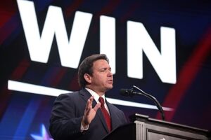 Desantis with Win sigh behind him