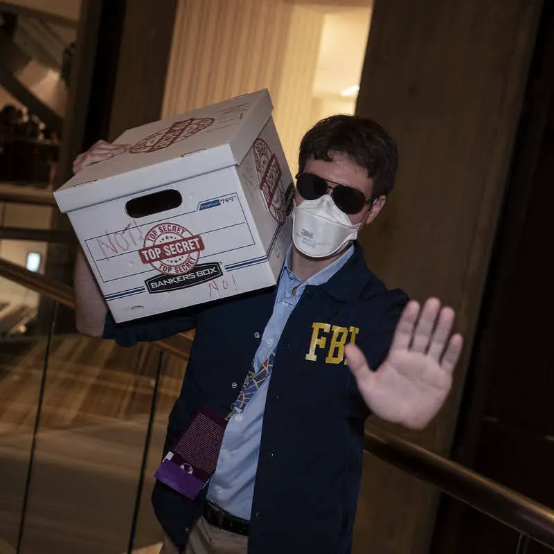 FBI Agent with mask and carrying a Top-Secret document box.